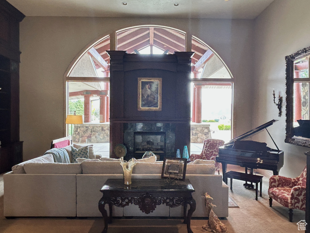 Carpeted living room with a premium fireplace