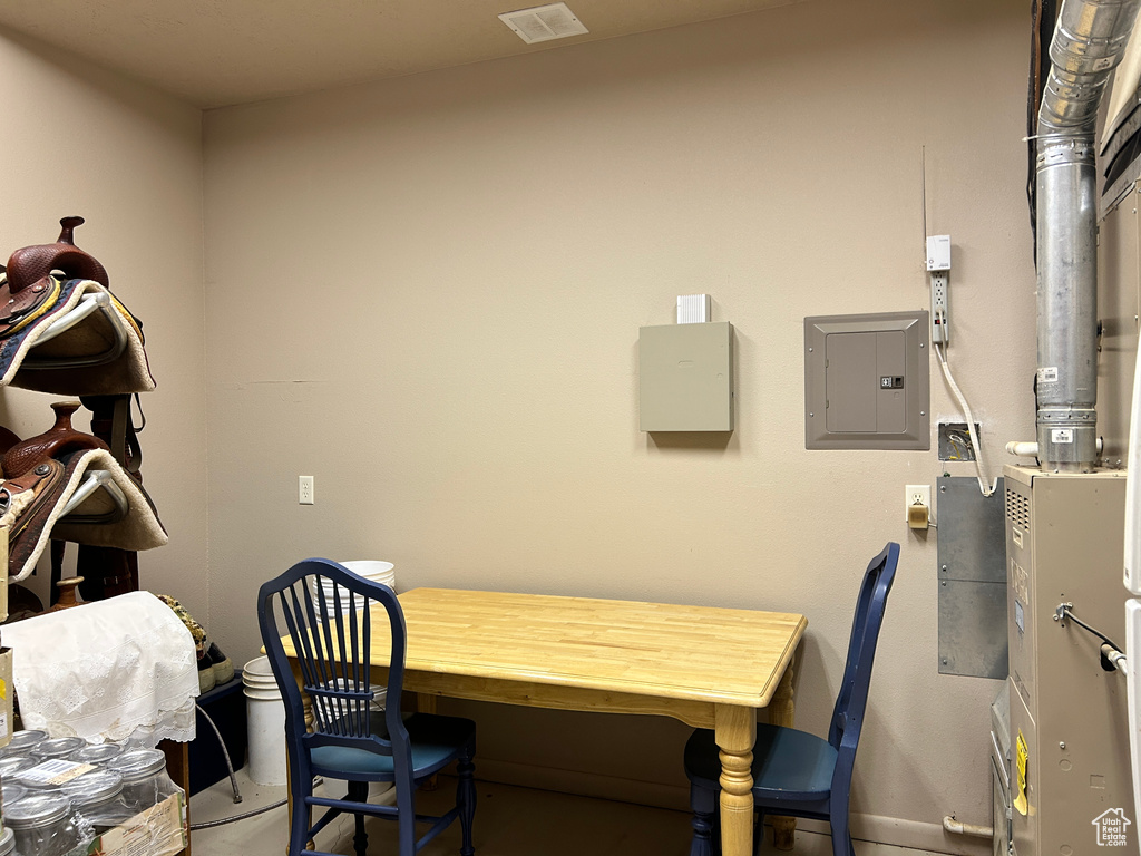 Office area featuring electric panel, baseboards, and visible vents