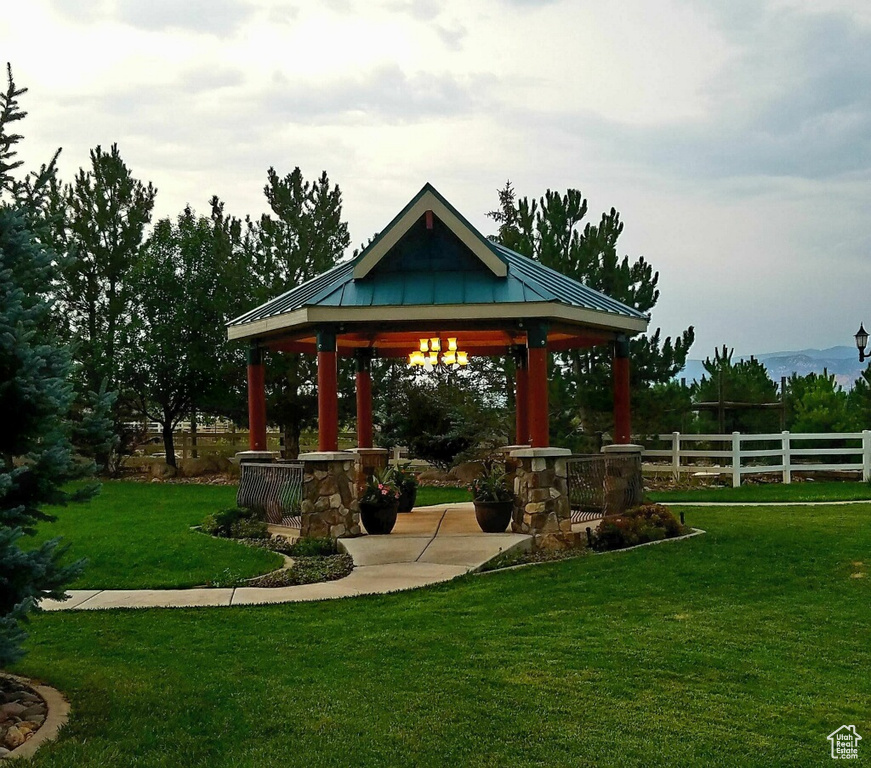 Exterior space with a yard, a gazebo, and fence