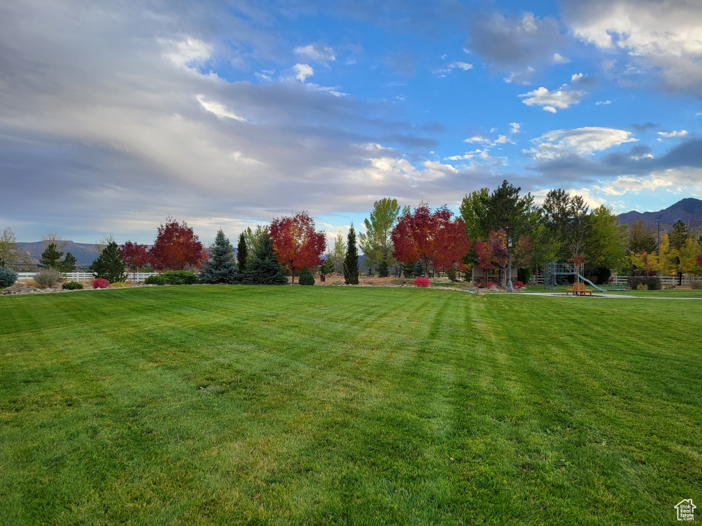 View of yard featuring playground community and a mountain view