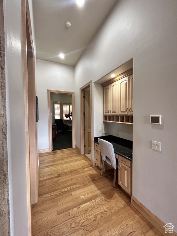 Corridor with light wood finished floors, baseboards, and recessed lighting