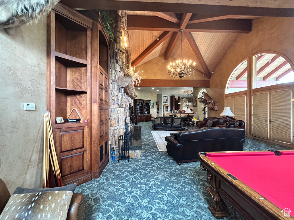 Recreation room with high vaulted ceiling, wooden ceiling, an inviting chandelier, beamed ceiling, and carpet floors