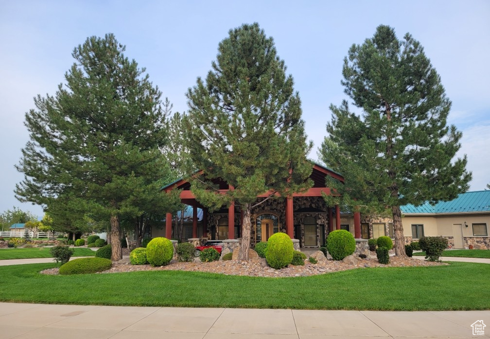 View of front facade with a front lawn and stone siding