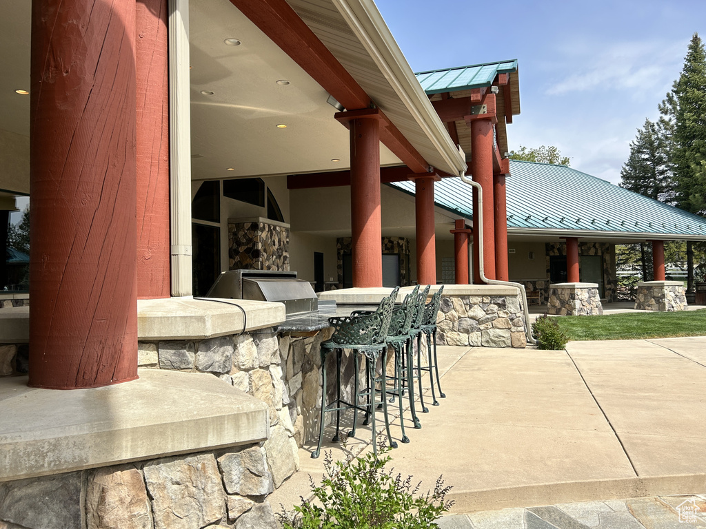 View of patio featuring an outdoor kitchen and outdoor wet bar