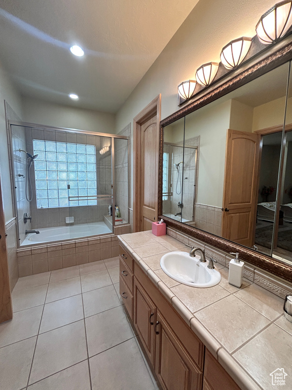 Full bathroom featuring recessed lighting, tile patterned flooring, vanity, and tiled shower / bath