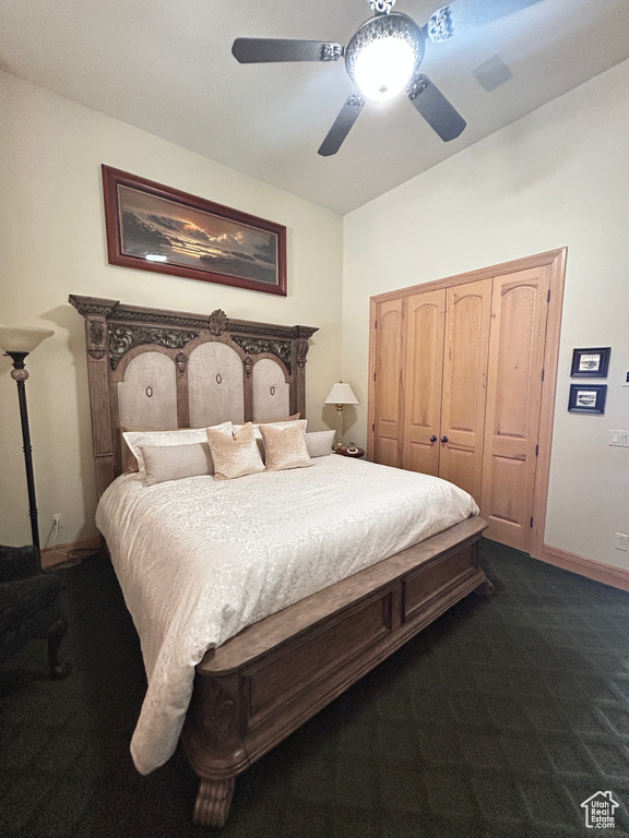 Bedroom with baseboards, dark carpet, a closet, and ceiling fan