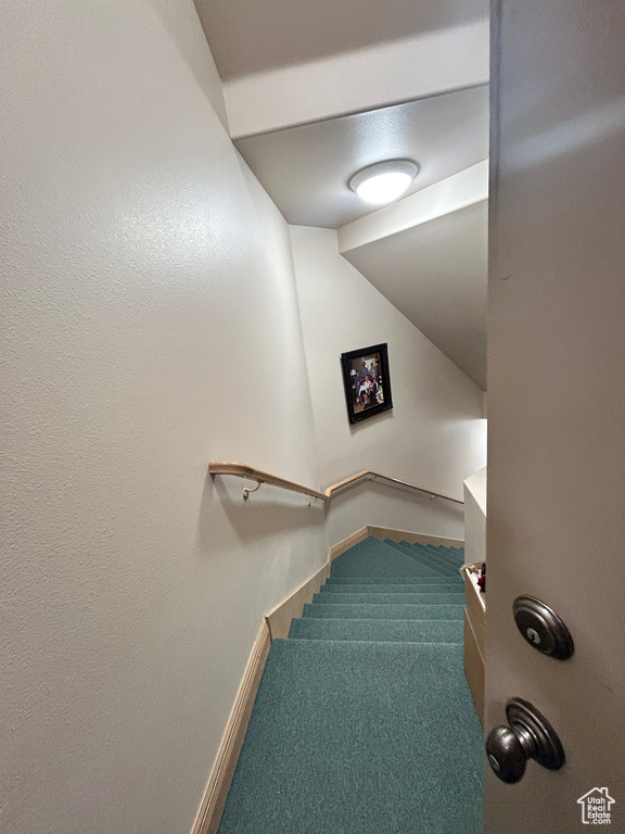 Stairway featuring carpet and baseboards