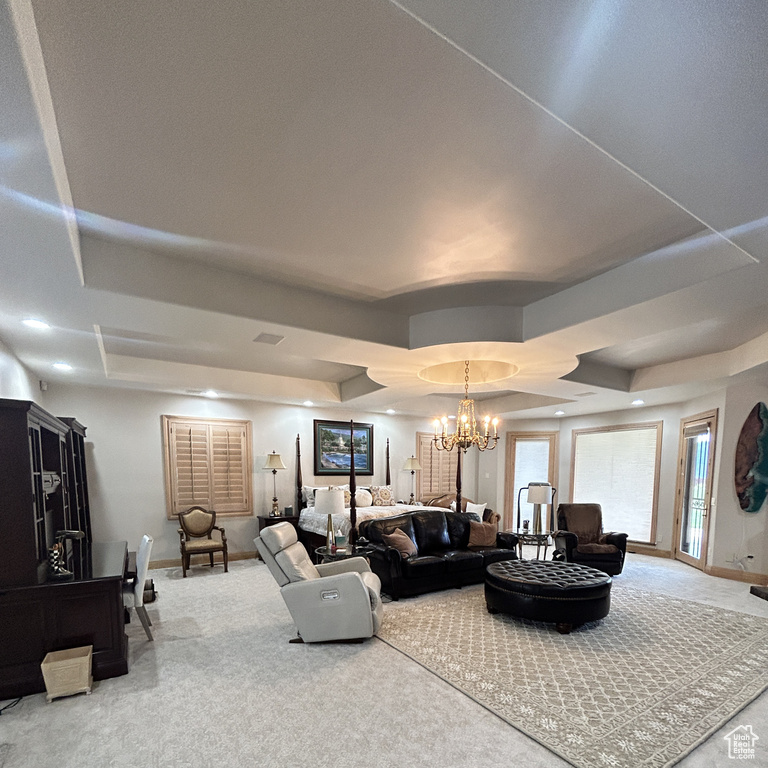 Living area with carpet floors, baseboards, and a notable chandelier