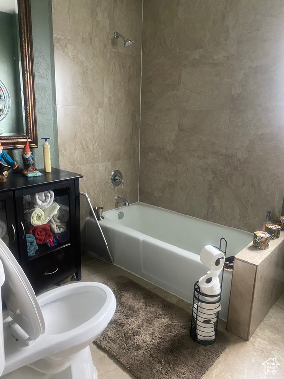 Full bath featuring tile patterned floors and shower / bath combination