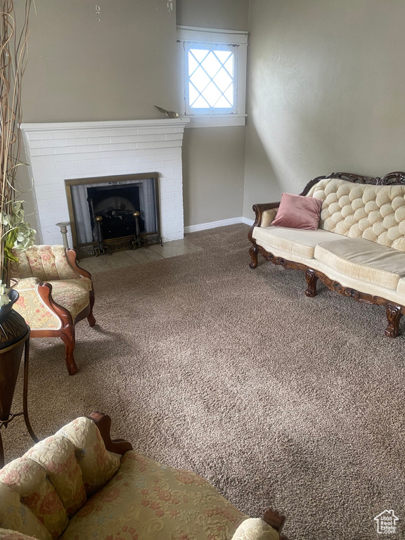 Living area with a fireplace, carpet flooring, and baseboards