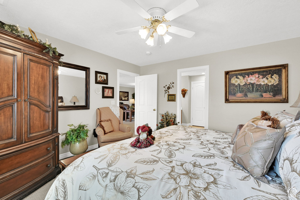 Bedroom with baseboards and a ceiling fan