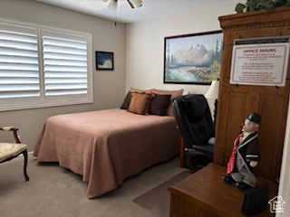Bedroom featuring a ceiling fan and light carpet