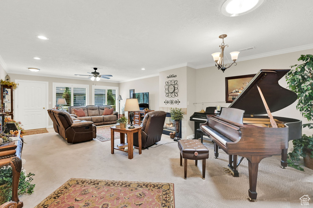 Living area with crown molding, light colored carpet, recessed lighting, a ceiling fan, and baseboards
