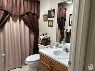 Bathroom featuring vanity, toilet, and tile patterned floors