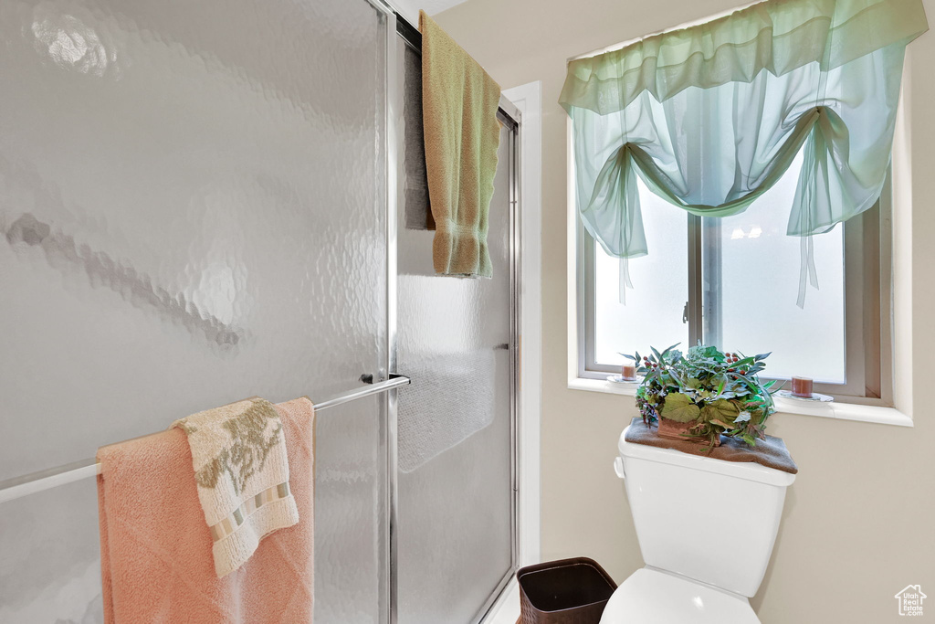 Bathroom featuring a stall shower and toilet