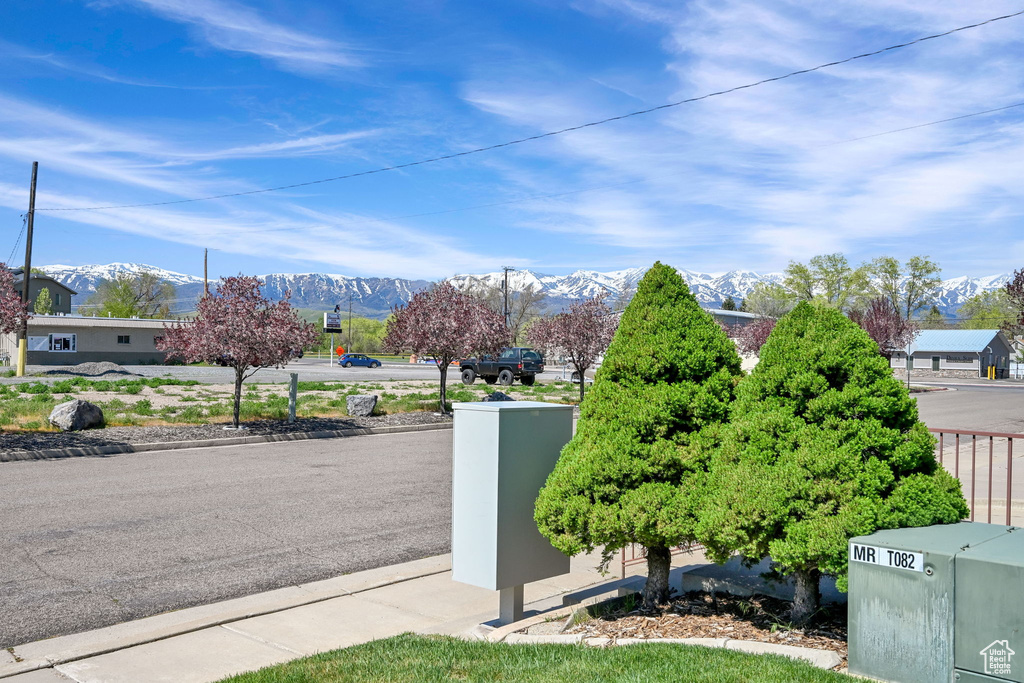 View of asphalt street featuring a mountain view