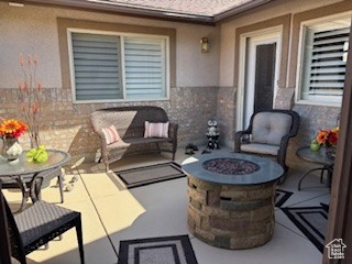 View of patio featuring a fire pit