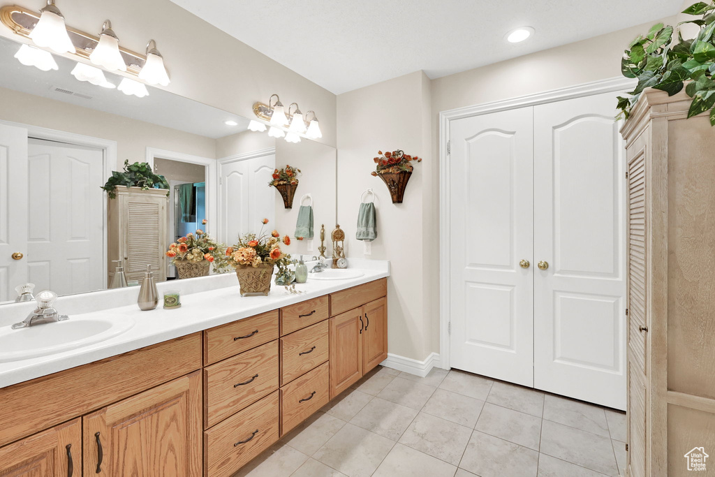 Full bath featuring tile patterned flooring, a closet, double vanity, and recessed lighting