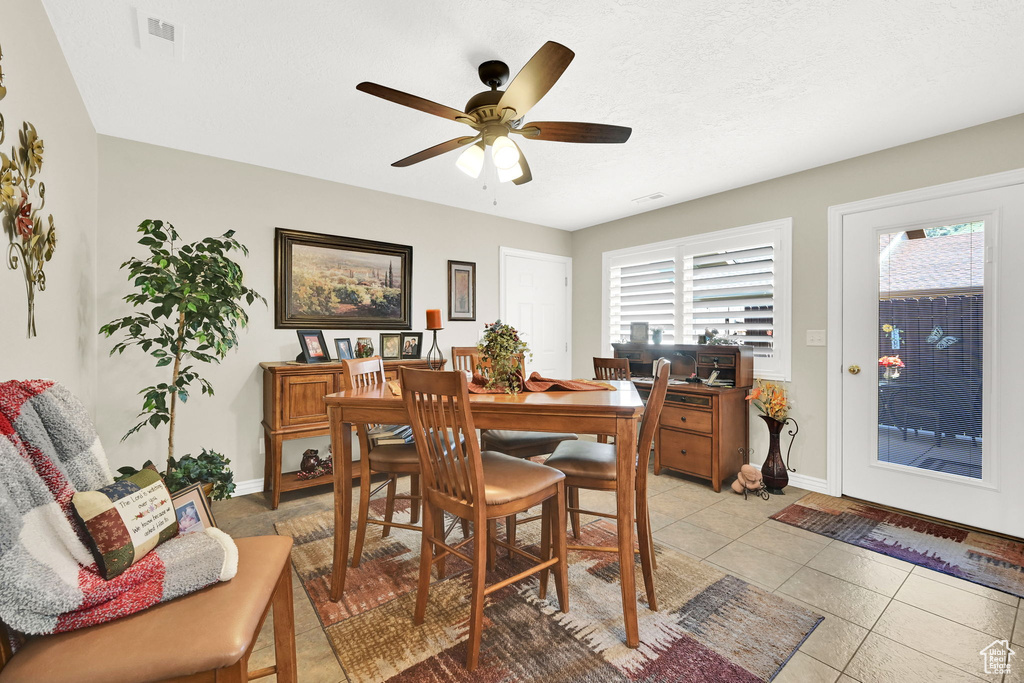 Dining area featuring plenty of natural light, baseboards, and light tile patterned floors