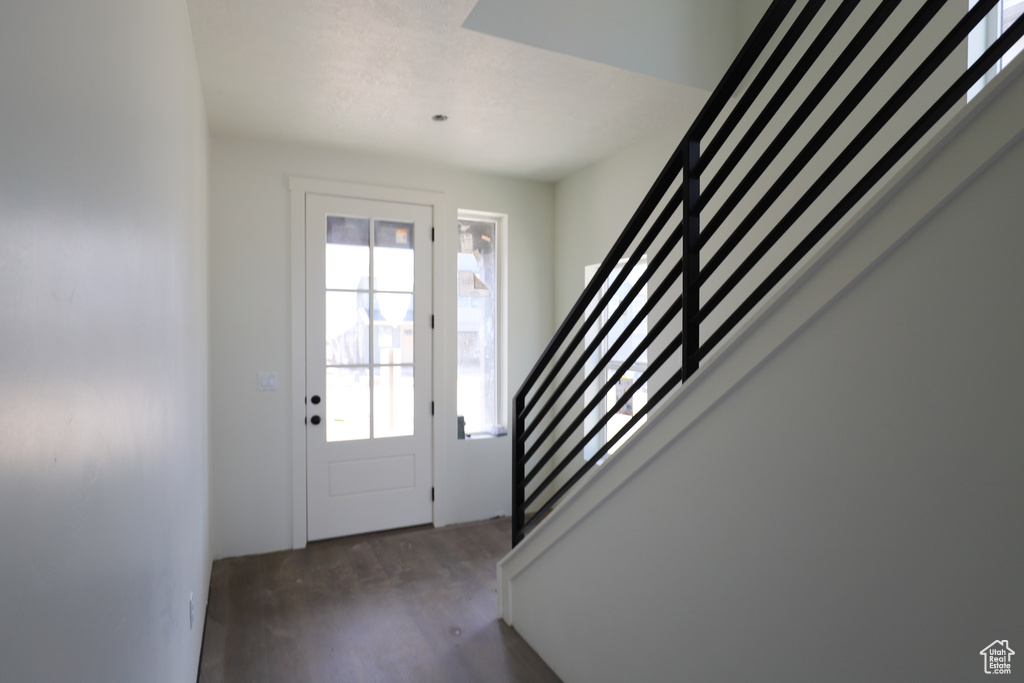Foyer entrance with stairs and wood finished floors