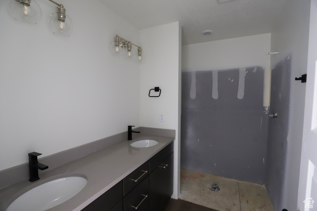 Full bathroom featuring a sink and double vanity