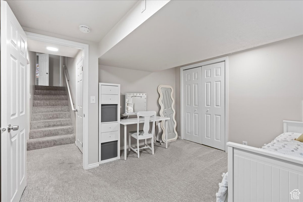 Carpeted bedroom featuring a closet and baseboards