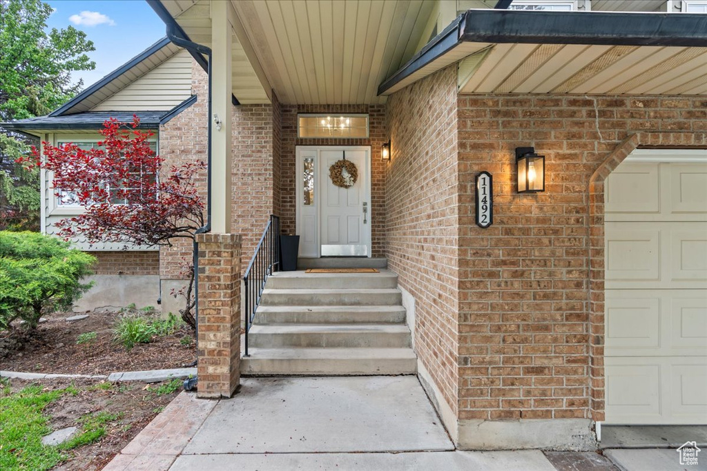 View of exterior entry with brick siding