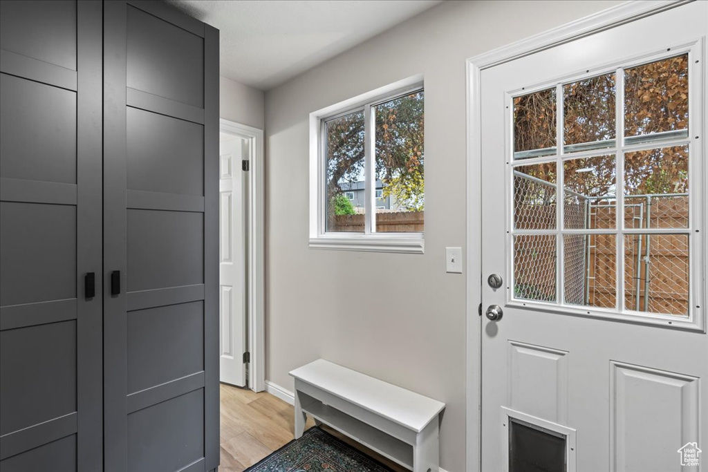 Mudroom featuring baseboards and light wood-type flooring