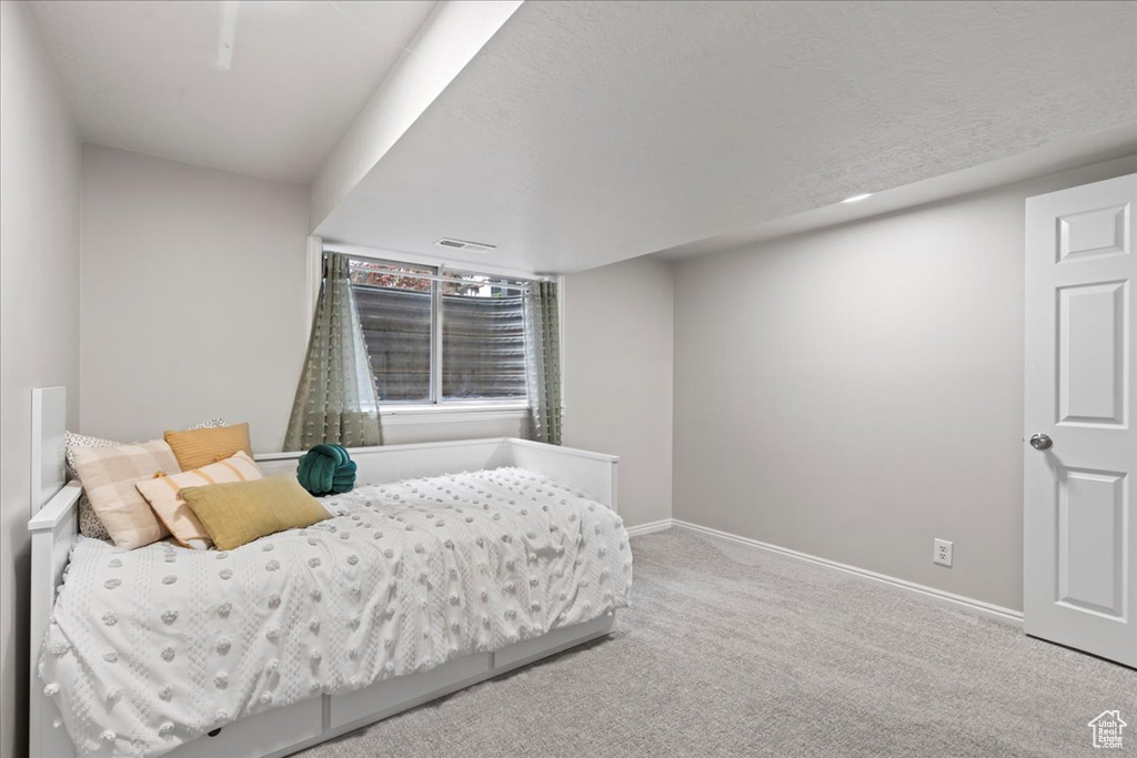 Bedroom featuring carpet floors, baseboards, and visible vents