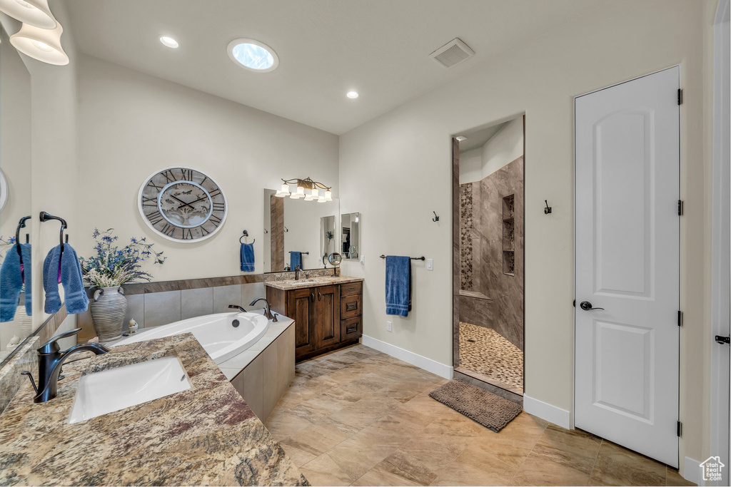 Full bathroom with visible vents, a tile shower, a sink, and a bath
