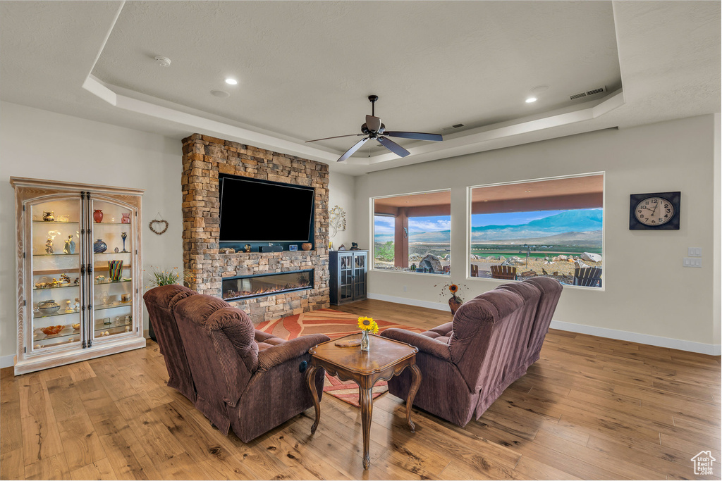 Living room featuring hardwood / wood-style flooring and a raised ceiling