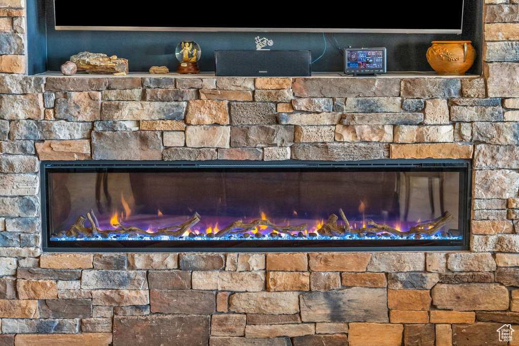 Exterior details featuring a glass covered fireplace and stone siding