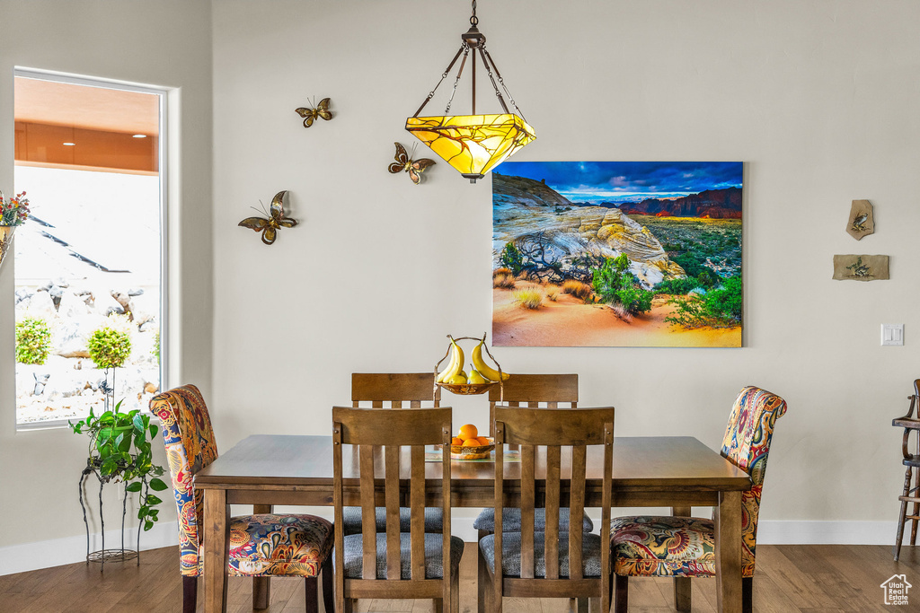 Dining area with baseboards and wood finished floors