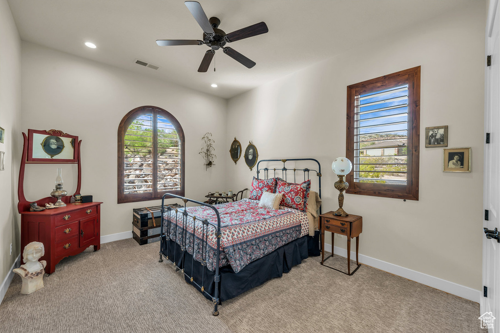 Carpeted bedroom with baseboards, ceiling fan, recessed lighting, and visible vents