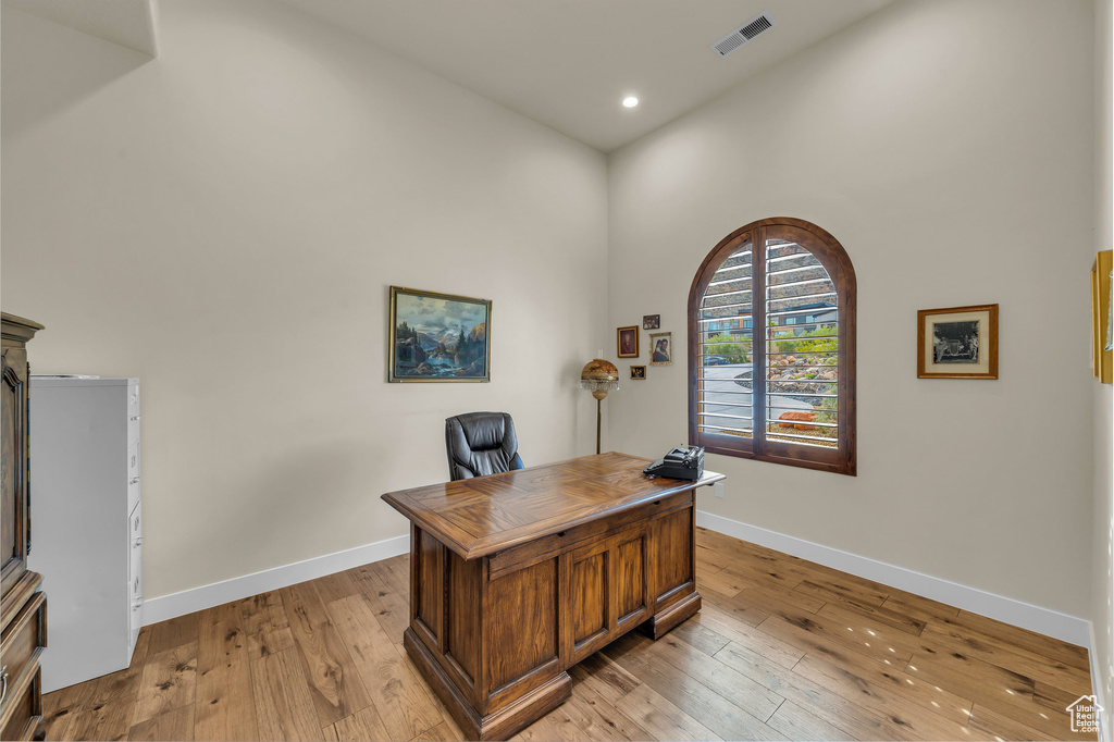 Home office featuring recessed lighting, baseboards, light wood finished floors, and visible vents