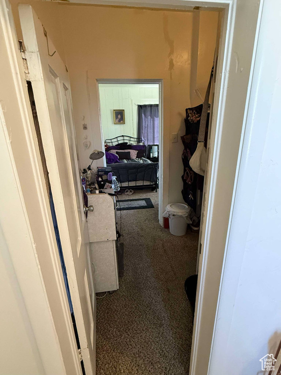 Corridor featuring carpet flooring