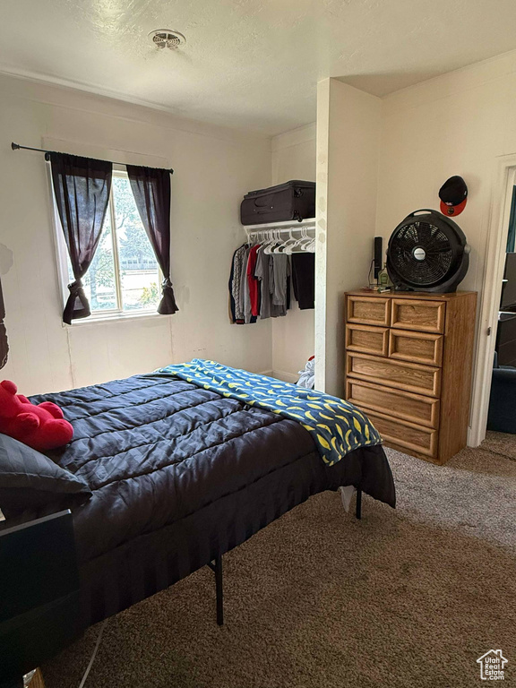 Bedroom featuring a textured ceiling and carpet flooring