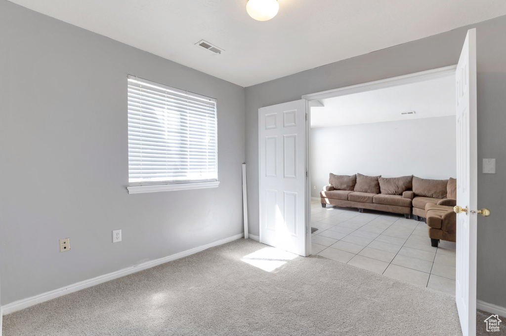 Interior space featuring baseboards, visible vents, and tile patterned floors
