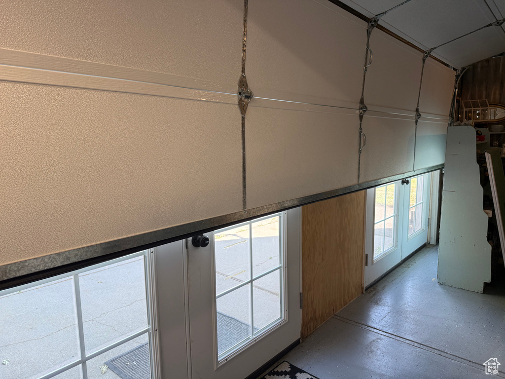 Hall featuring finished concrete flooring and a textured wall