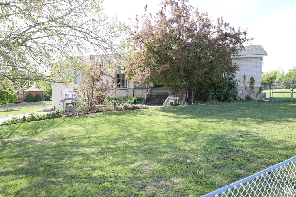 View of yard with stairway and fence
