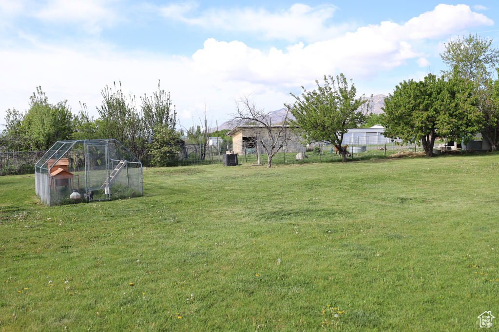 View of yard with an outdoor structure, exterior structure, and fence