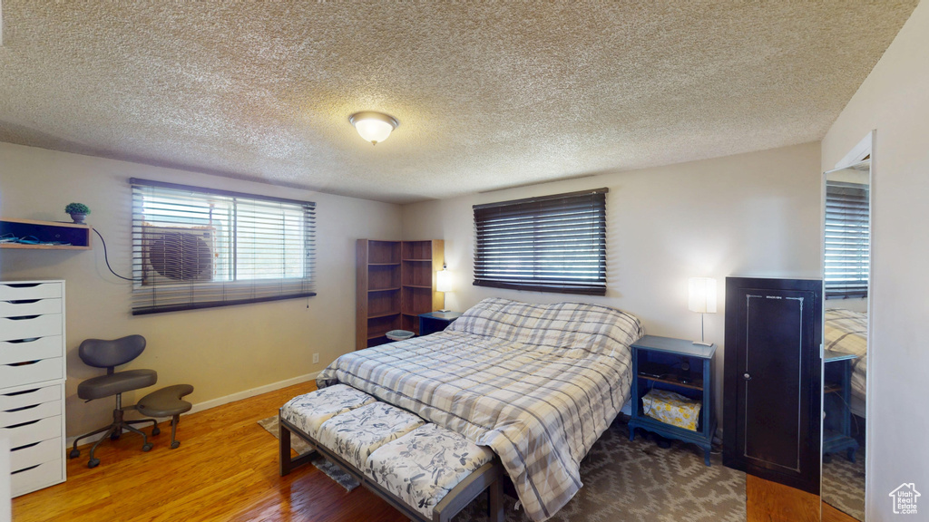 Bedroom featuring wood finished floors and a textured ceiling