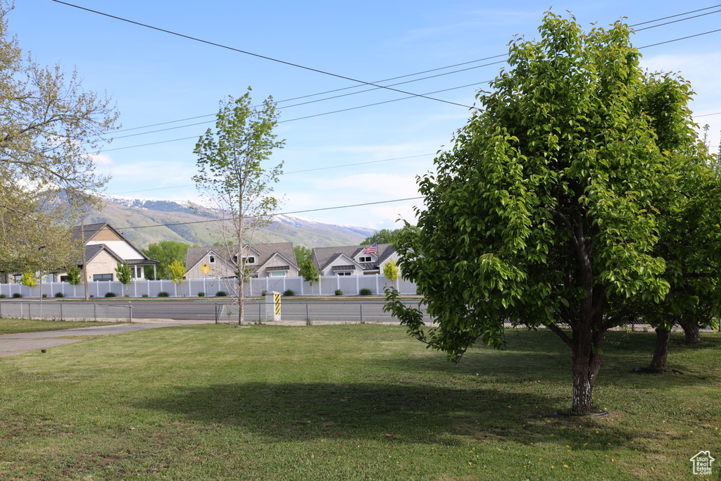 View of yard featuring a residential view, a mountain view, and fence