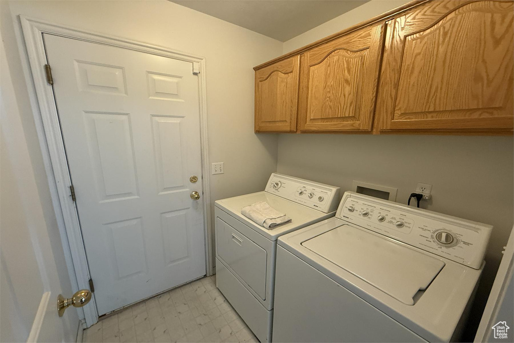 Laundry room featuring washing machine and dryer and cabinet space