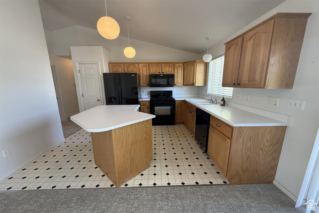 Kitchen with a sink, black appliances, light countertops, a kitchen island, and lofted ceiling