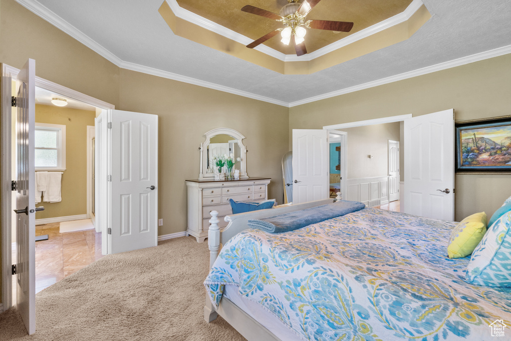 Bedroom featuring crown molding, a ceiling fan, and a raised ceiling