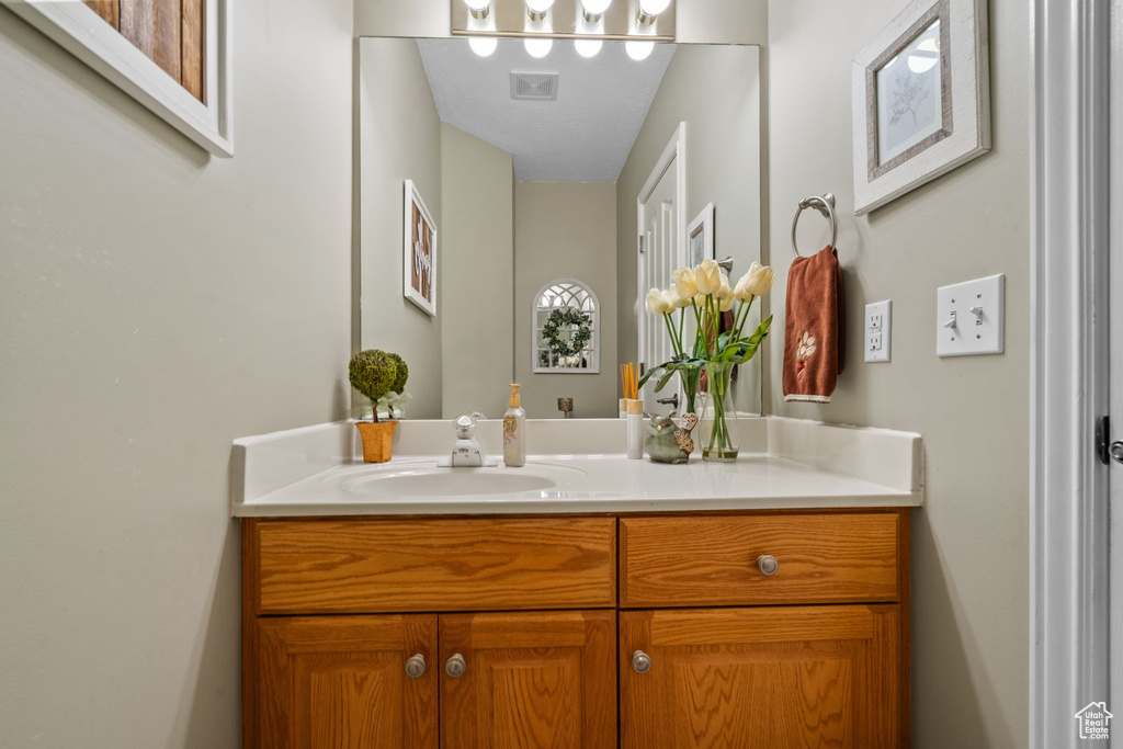 Bathroom featuring visible vents and vanity