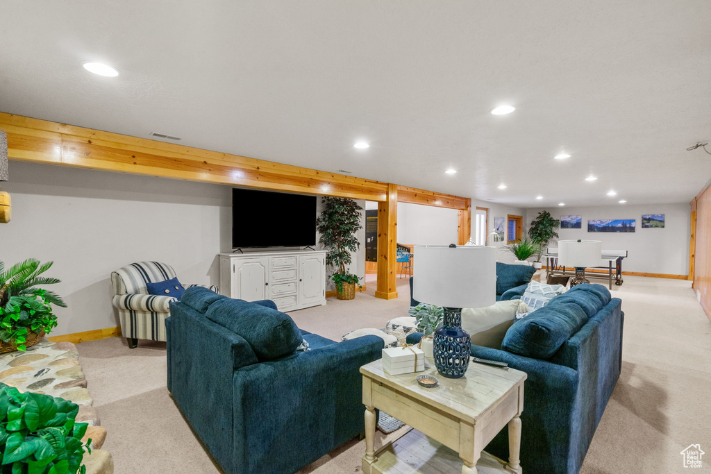 Living area featuring baseboards, recessed lighting, and light carpet