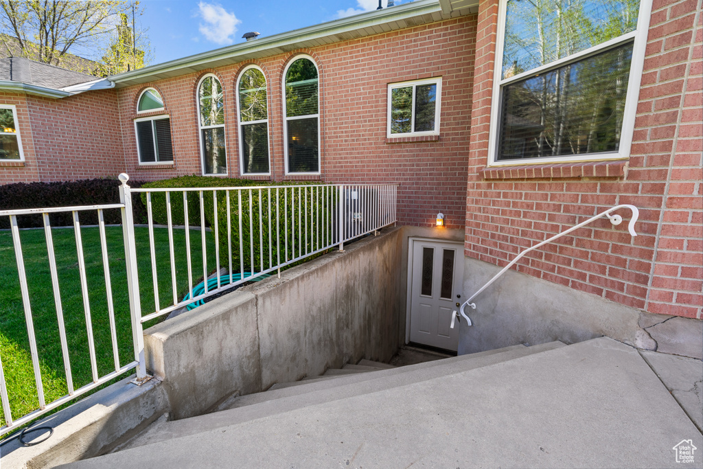 Exterior space with a lawn and brick siding