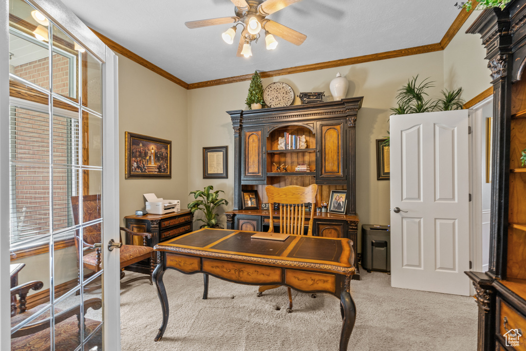 Office area featuring crown molding, a ceiling fan, and light colored carpet